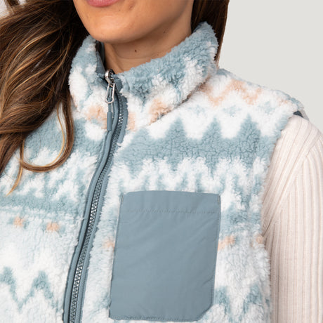 [Olga is 5’9" wearing a size Small.] Woman wearing the Free Country Women's Venture Stratus Lite Reversible Vest in light blue, featuring a geometric-print Butter Pile® lining and horizontal quilted overlay