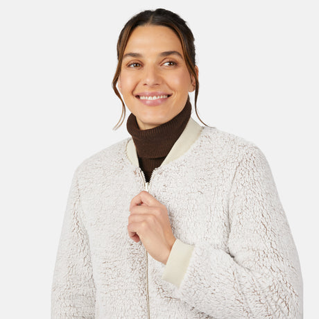 [Olga is 5'9" wearing size S.] Woman wearing a white sherpa jacket with a plain background