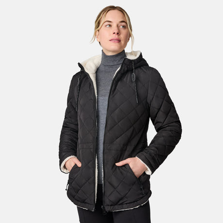 [CJ is 5'10" wearing size S.] Woman wearing Free Country Women's Switch It Up Cloud Lite Reversible Jacket in black with a full front zipper opening, attached hood with adjustable drawcord, diamond quilting, soft lining, and water resistant and wind resistant stretch performance fabric. light grey background. Perfect women’s  jacket for fall weather.