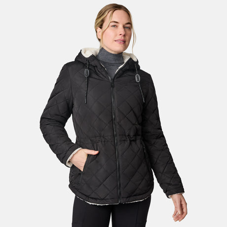 [CJ is 5'10" wearing size S.] Woman wearing Free Country Women's Switch It Up Cloud Lite Reversible Jacket in black with a full front zipper opening, attached hood with adjustable drawcord, diamond quilting, soft lining, and water resistant and wind resistant stretch performance fabric. light grey background. Perfect women’s  jacket for fall weather.