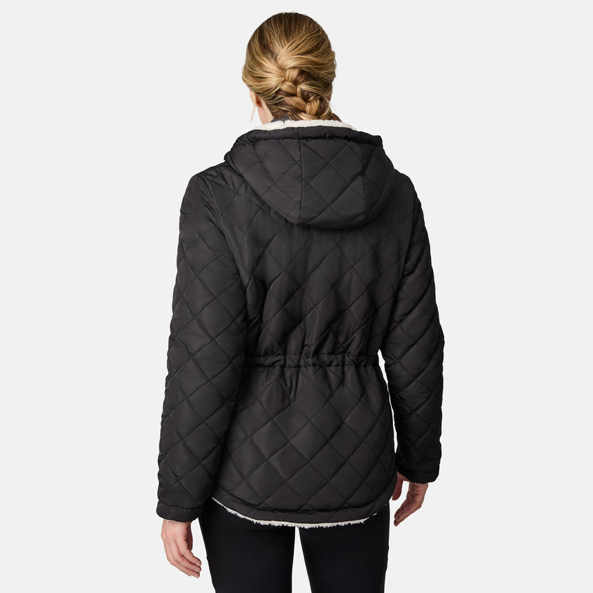 [CJ is 5'10" wearing size S.] Woman wearing Free Country Women's Switch It Up Cloud Lite Reversible Jacket in black with a full front zipper opening, attached hood with adjustable drawcord, diamond quilting, soft lining, and water resistant and wind resistant stretch performance fabric. light grey background. Perfect women’s  jacket for fall weather.