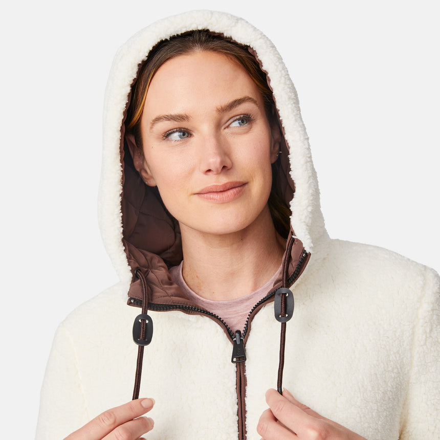 [Emily is 5'9" wearing size S.] Model wearing brown quilted jacket with hood and black pants — reversible design with cream pile interior for cozy, cold-weather layering