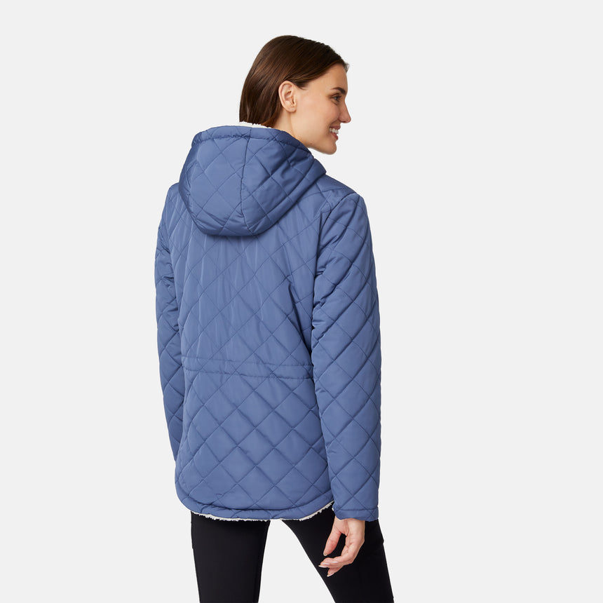 [Jessica is 5'9.5" wearing size S.] Model wearing blue quilted jacket with hood and black pants — reversible design with cream pile interior for cozy, cold-weather layering