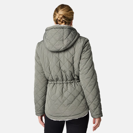 [CJ is 5'10" wearing size S.] Woman wearing Free Country Women's Switch It Up Cloud Lite Reversible Jacket in green with a full front zipper opening, attached hood with adjustable drawcord, diamond quilting, soft lining, and water resistant and wind resistant stretch performance fabric. light grey background. Perfect women’s  jacket for fall weather.