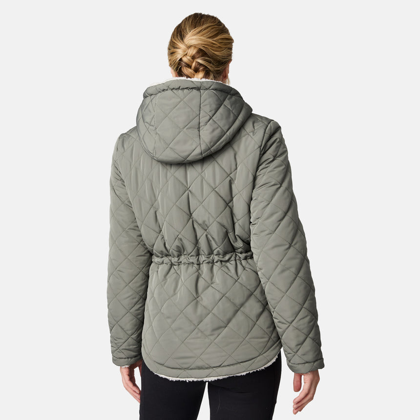 [CJ is 5'10" wearing size S.] Woman wearing Free Country Women's Switch It Up Cloud Lite Reversible Jacket in green with a full front zipper opening, attached hood with adjustable drawcord, diamond quilting, soft lining, and water resistant and wind resistant stretch performance fabric. light grey background. Perfect women’s  jacket for fall weather.