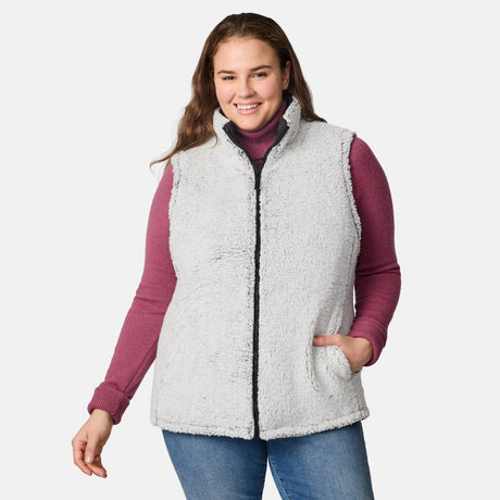 [Karissa is 5'9.5" wearing size 1X.]  Women’s Free Country black diamond-quilted vest with zip-front closure—reverses to cozy sherpa for added warmth and texture. Worn open over a pink knit sweater and blue jeans for a relaxed, cold-weather look.