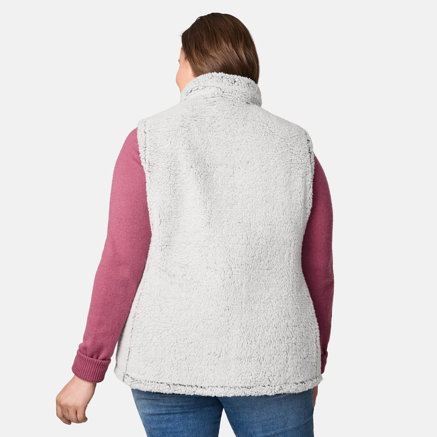 [Karissa is 5'9.5" wearing size 1X.]  Women’s Free Country black diamond-quilted vest with zip-front closure—reverses to cozy sherpa for added warmth and texture. Worn open over a pink knit sweater and blue jeans for a relaxed, cold-weather look.