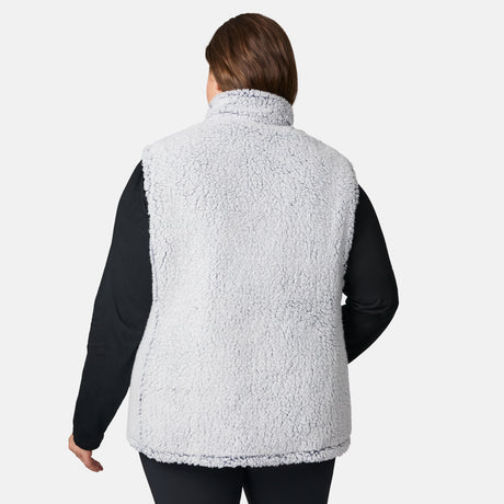 [Karissa is 5'9.5" wearing size 1X.] Women’s Free Country blue quilted vest with zip-front closure and zippered pockets—reverses to cozy sherpa for added warmth and texture. Worn over a black long-sleeve shirt and blue pants for a casual, transitional-weather look.
