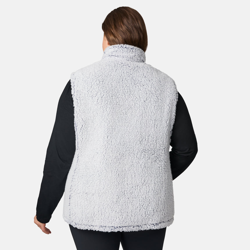 [Karissa is 5'9.5" wearing size 1X.] Women’s Free Country blue quilted vest with zip-front closure and zippered pockets—reverses to cozy sherpa for added warmth and texture. Worn over a black long-sleeve shirt and blue pants for a casual, transitional-weather look.