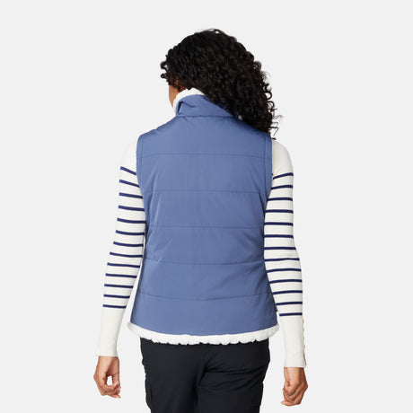 [Angelique is 5'10" wearing size S.] Person wearing a blue puffer vest over a striped shirt on a white background