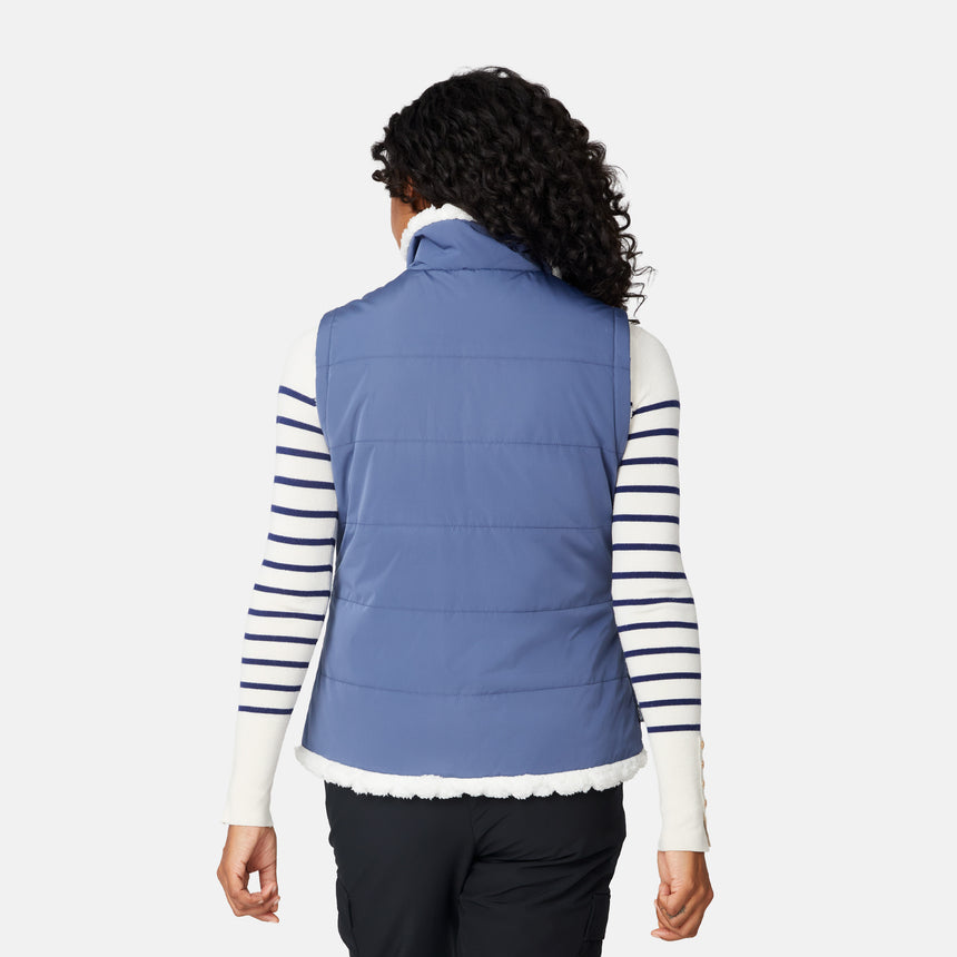[Angelique is 5'10" wearing size S.] Person wearing a blue puffer vest over a striped shirt on a white background