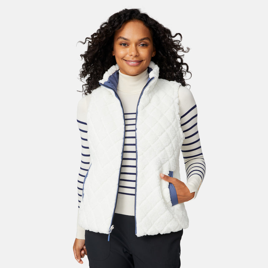 [Angelique is 5'10" wearing size S.] Woman wearing a white quilted vest with blue accents on a light gray background