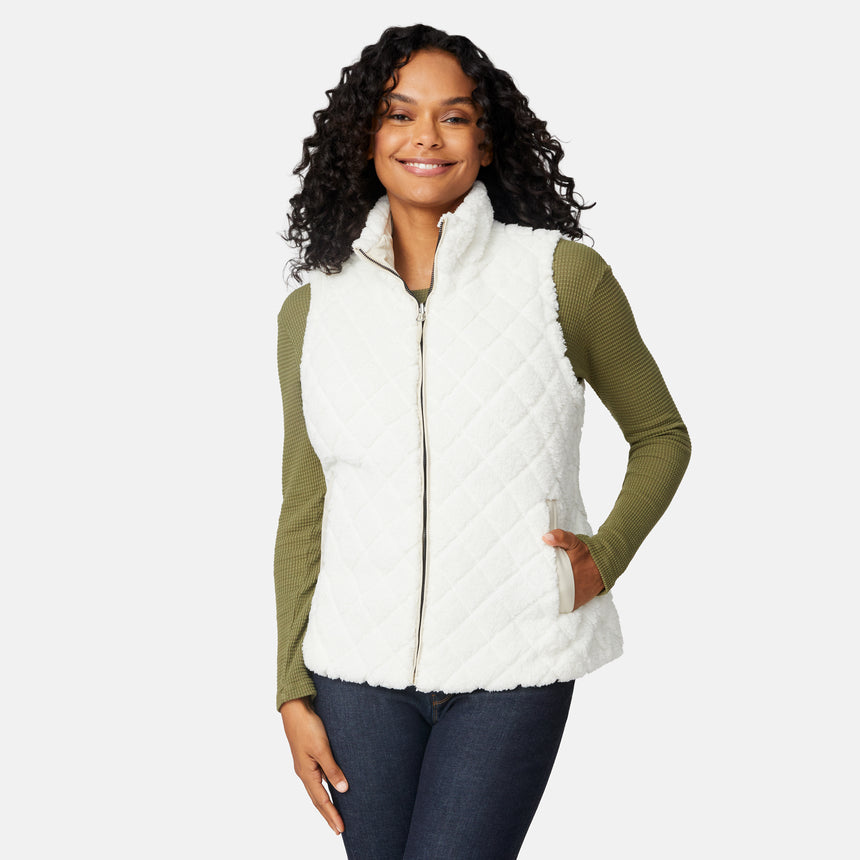 [Angelique is 5'10" wearing size S.] Woman wearing a white puffer vest over an olive green long-sleeve shirt on a light gray background
