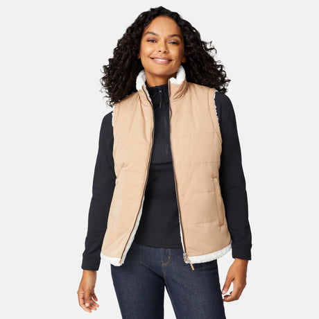 [Angelique is 5'10" wearing size S.] Woman wearing a beige quilted vest over a black long-sleeve shirt on a white background