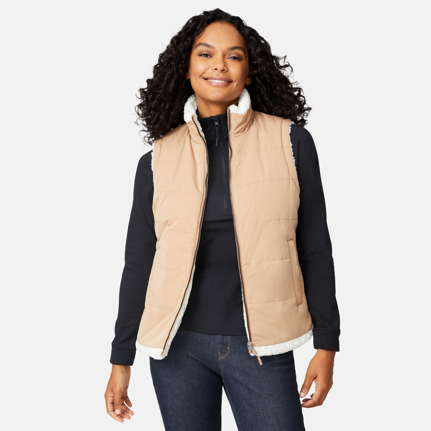 [Angelique is 5'10" wearing size S.] Woman wearing a beige quilted vest over a black long-sleeve shirt on a white background