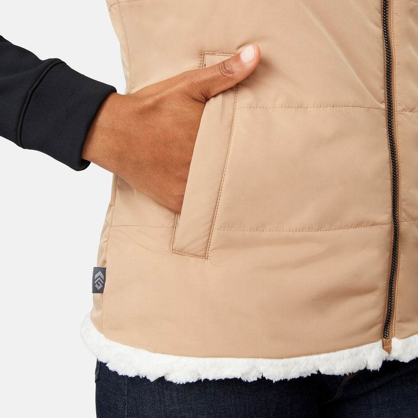 [Angelique is 5'10" wearing size S.] Close-up of a person wearing a beige quilted jacket with a brand logo on a white background