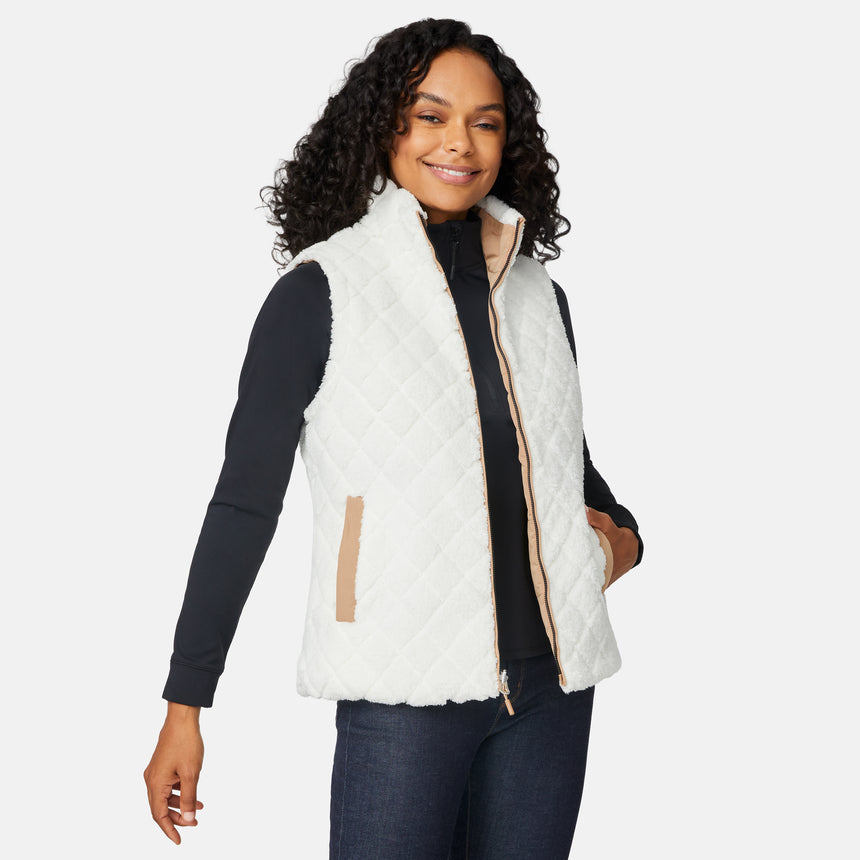 [Angelique is 5'10" wearing size S.] Woman wearing a white quilted vest on a white background