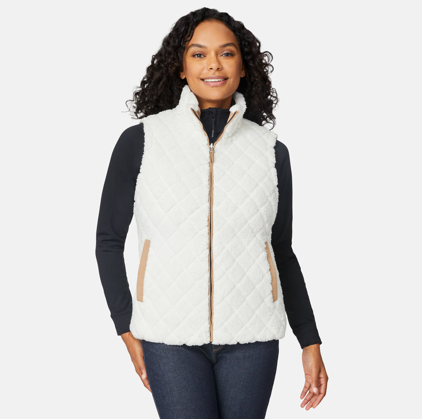 [Angelique is 5'10" wearing size S.] Woman wearing a white quilted vest over a black long-sleeve shirt on a white background