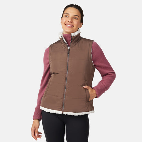 [Olga is 5'9" wearing size S.] Woman wearing a brown quilted vest over a pink long-sleeve shirt on a white background