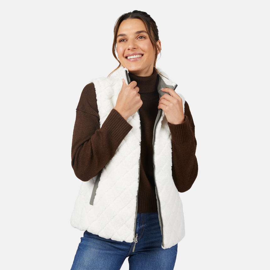 [Olga is 5'9" wearing size S.] Woman wearing a white fleece vest over a brown sweater on a white background