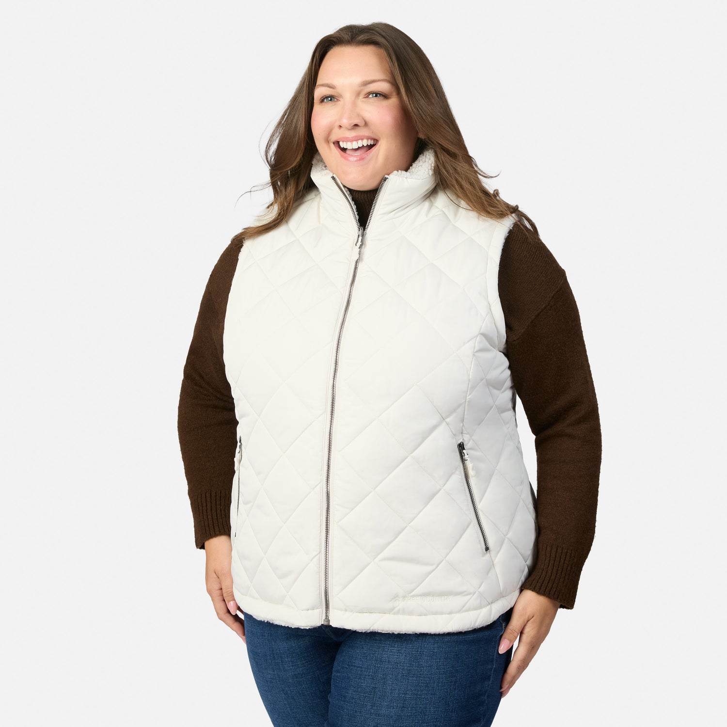 Plus size Stratus Lite II reversible vest white quilted exterior with front zipper over a brown knit sweater