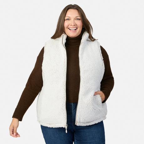 Model wearing the Stratus Lite II reversible vest with white sherpa exterior and brown sleeves zip closure