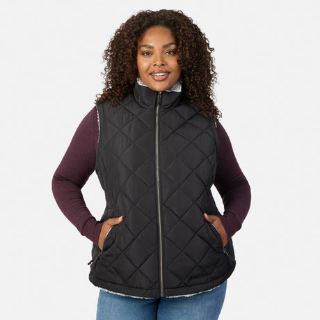 Plus size woman wearing a black quilted Stratus Lite II reversible vest with white fleece lining and burgundy sleeves peeking out