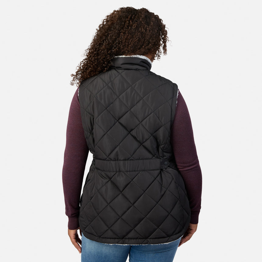 Back view of a woman wearing the Stratus Lite II reversible vest in black quilted fabric with sherpa collar