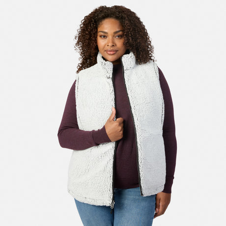 Plus size woman wearing the white sherpa reverse of the Stratus Lite II vest with burgundy sleeves visible