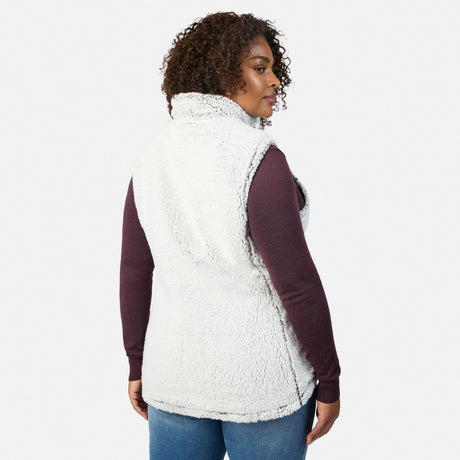 Side view of a woman wearing the Stratus Lite II reversible vest in white sherpa over a burgundy long sleeve top