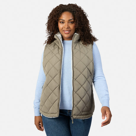 Plus-size woman wearing the reversible Stratus Lite II vest with white sherpa lining and olive exterior