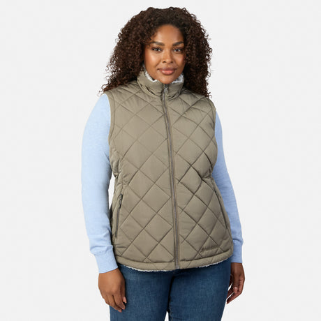 Plus-size woman wearing olive quilted Stratus Lite II reversible vest over a light blue sweater