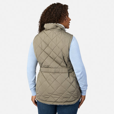 Back view of a woman wearing the taupe quilted Stratus Lite II Reversible Vest over a light blue sweater.