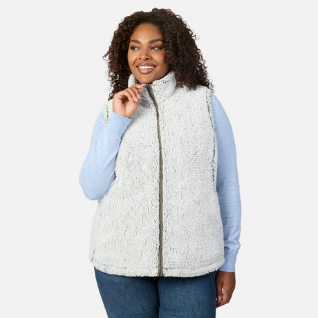 Plus size woman wearing the Women's Plus Size Stratus Lite II Reversible Vest in light gray sherpa with zipper over a light blue sweater.