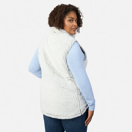 Side profile of a woman wearing the Women's Plus Size Stratus Lite II Reversible Vest in white sherpa with zipper visible.