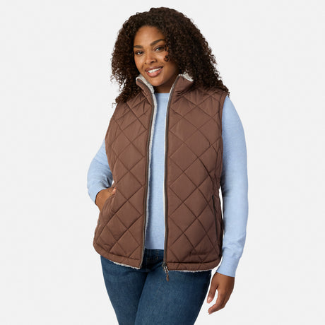 Plus size woman wearing brown quilted Stratus Lite II reversible vest over a light blue sweater