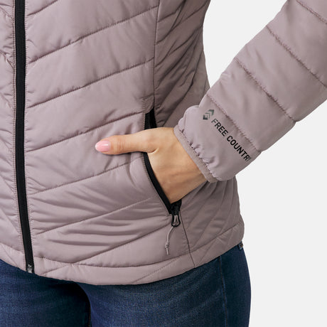 A person wears the Clearance Women's Stow & Go Packable Jacket in light purple, featuring quilting and water resistance, with their right hand in a zippered pocket. The packable jacket is paired with blue jeans.