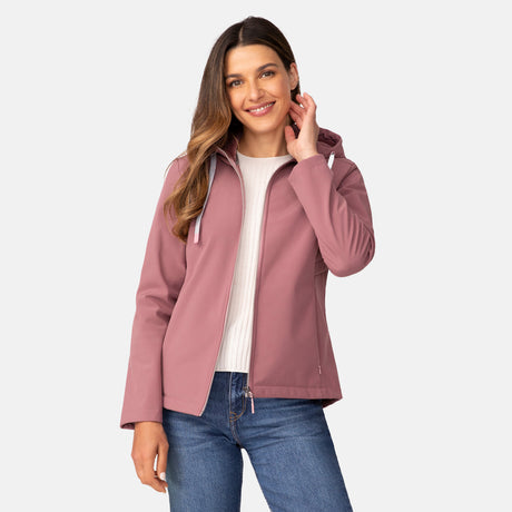 [Olga is 5’9” wearing a size Small.] Woman wearing Free Country Women's Alps Super Softshell® Jacket in pink with a full front zipper opening, soft lining, attached hood with adjustable drawcords, and water resistant and wind resistant stretch performance fabric, light grey background. Perfect women’s  jacket for fall weather.