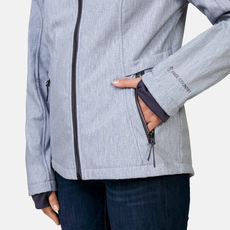 [Megan is 5’6” wearing a size Small.] Woman wearing Free Country Women's Aeris II Super Softshell® Jacket in textured grey with a full front zipper opening, soft lining, detachable hood, and water resistant and wind resistant stretch performance fabric, light grey background. Perfect women’s  jacket for fall weather.