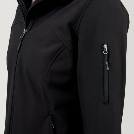 A close-up of the Women's FreeCycle® Super Softshell® Jacket by Clearance highlights the zippered sleeve pocket, chest, and shoulder area. The smooth black fabric is slightly fitted and features four-way stretch for comfort.