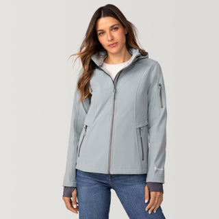 [Olga is 5’9” wearing a size Small.] Woman wearing Free Country Women's Aeris II Super Softshell® Jacket in light blue with a full front zipper opening, soft lining, detachable hood, and water resistant and wind resistant stretch performance fabric, light grey background. Perfect women’s  jacket for fall weather.