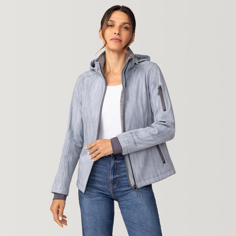 Woman wearing a light gray Women’s Aeris II Super Softshell® Jacket with a zipper closure and zippered pockets, over a white top and blue jeans.