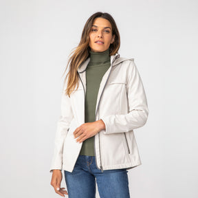 [Olga is 5’9" wearing a size Small.] Woman wearing Free Country Women's TrailTrek Super Softshell® Jacket in white with a full front zipper opening, lower pockets, soft lining, a hood with an adjustable drawcord, and water resistant and wind resistant stretch performance fabric, light grey background. Best women’s jacket for winter weather.