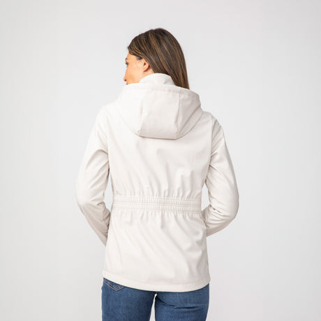 [Olga is 5’9" wearing a size Small.] Woman wearing Free Country Women's TrailTrek Super Softshell® Jacket in white with a full front zipper opening, lower pockets, soft lining, a hood with an adjustable drawcord, and water resistant and wind resistant stretch performance fabric, light grey background. Best women’s jacket for winter weather.