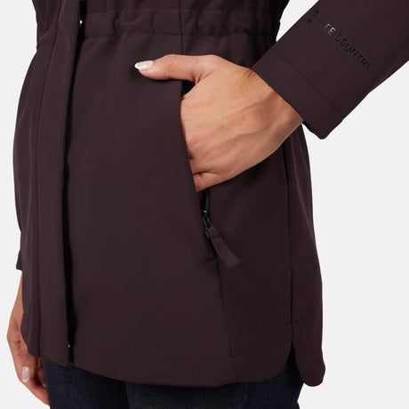 [Jessica is 5'9.5" wearing size S.] Women’s dark-brown hooded softshell jacket with zip-front closure, flap chest pockets, and adjustable drawstrings—features a sleeve patch and is paired with dark pants for a rugged, outdoor-ready look.