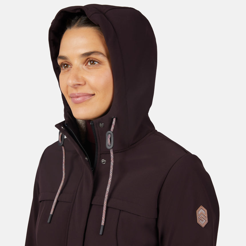 [Jessica is 5'9.5" wearing size S.] Women’s dark-brown hooded softshell jacket with zip-front closure, flap chest pockets, and adjustable drawstrings—features a sleeve patch and is paired with dark pants for a rugged, outdoor-ready look.