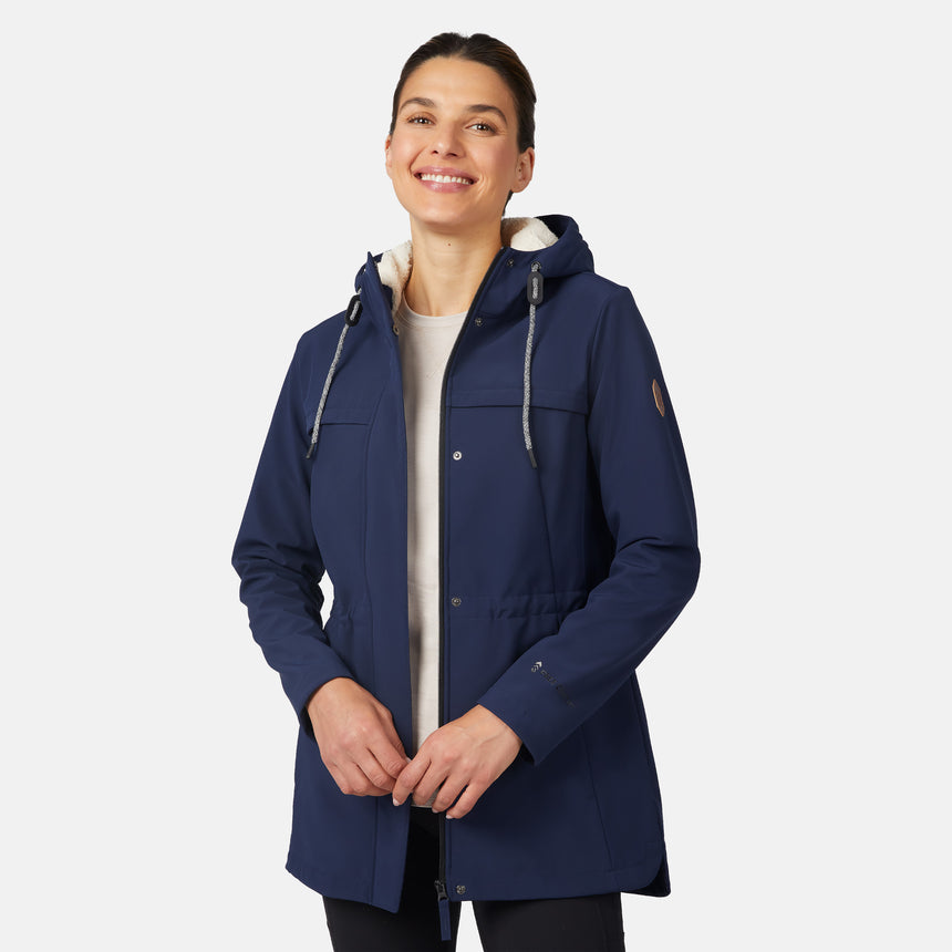 [Jessica is 5'9.5" wearing size S.] Free Country navy blue women’s softshell jacket with a fitted silhouette, zip-front closure, long sleeves, and adjustable hood drawstrings—styled with black pants for a sleek, minimalist outdoor look.