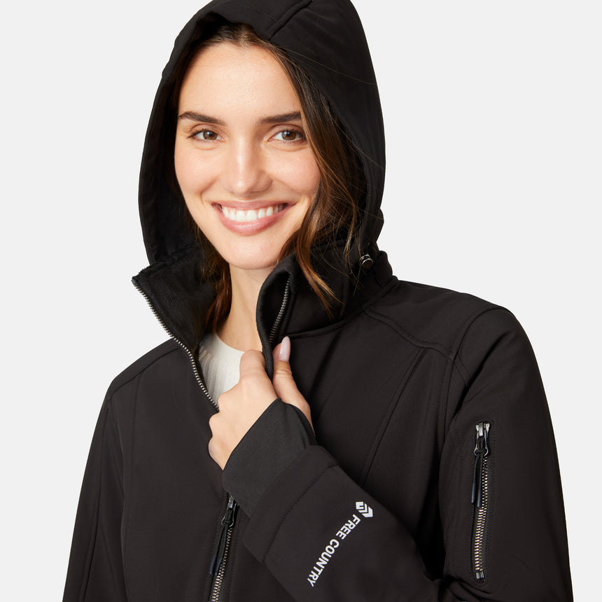 [Jessica is 5'9.5" wearing size S.] Woman wearing Free Country Women's Aeris II Super Softshell® Jacket in black with a full front zipper opening, soft lining, detachable hood, and water resistant and wind resistant stretch performance fabric, light grey background. Perfect women’s  jacket for fall weather.