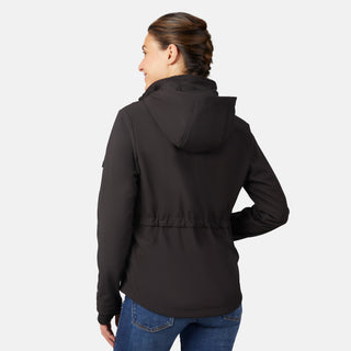 A woman with brown braided hair is wearing a black Free Country Women's StormTech Super Softshell® Jacket and blue jeans, smiling with her back to the camera against a plain light gray background.