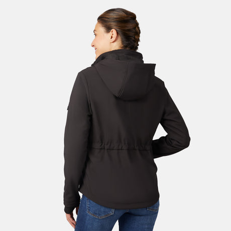A woman with brown braided hair is wearing a black Free Country Women's StormTech Super Softshell® Jacket and blue jeans, smiling with her back to the camera against a plain light gray background.